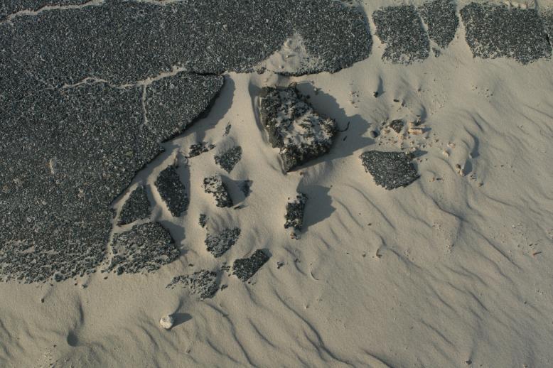 naturally sculpted arraingment of sand and pavement crumblings.