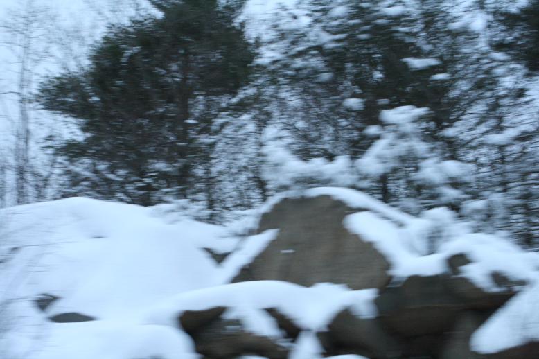 Using a 1600 iso setting those 'out the window of the moving car' shots can give and interesting image.  We see here road cuts covered with newly fallen snow.  It makes a roadside rock ledge look like giant snow-covered mountains.  Jan 3, 2009.