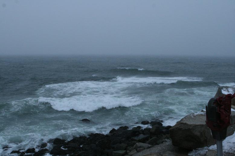 The ocean from Bears Neck in Rockport, MA  Jan 3, 2009.  Very large waves crash below the bluff in a turbulent ocean.  Note the parking meter in the foregroud to give perspective to the size of these wave!