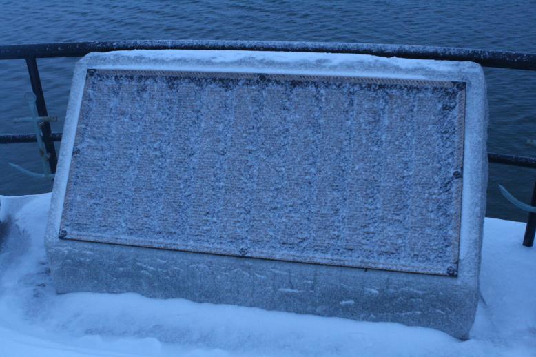 Even Covered in Ice, they are never forgotten.  Detail of the Plagues, Fisherman's Memorial, Glochestor, MAJan 3, 2009.  Very large waves crash below the bluff in a turbulent ocean.  